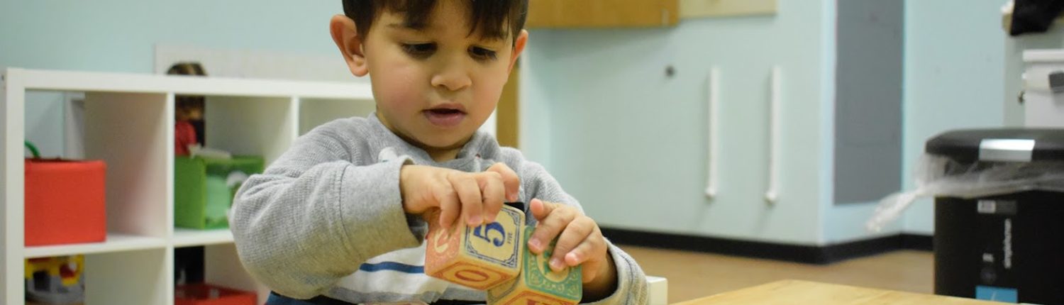 Montessori School boy playing with blocks