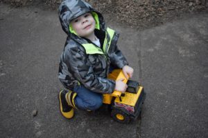 Boy on a small truck at Montessori Kirkland playground