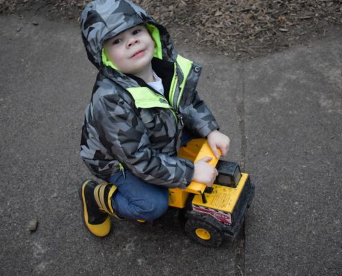 Boy on a small truck at Montessori Kirkland playground