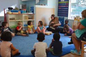 Day care teacher in classroom with kids