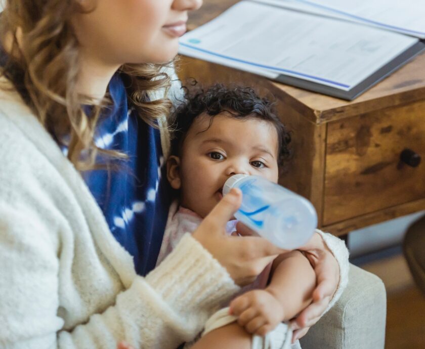 Infant being fed with bottle.