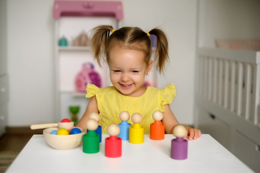 Little girl using Montessori development tools.