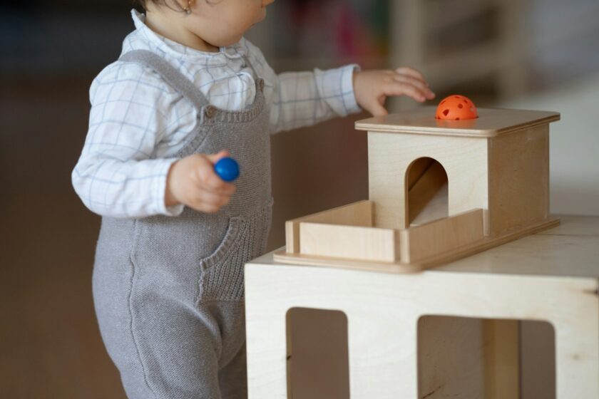 Child using Montessori development tools.